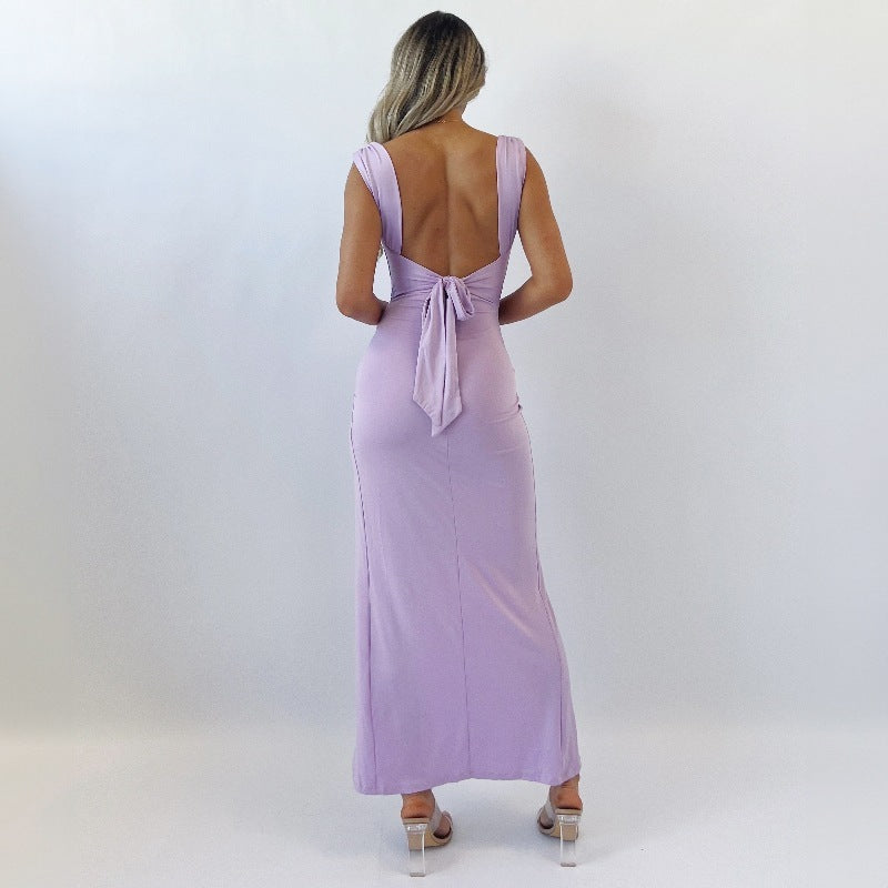 Elegant slit dress featuring open back with bow tie accent