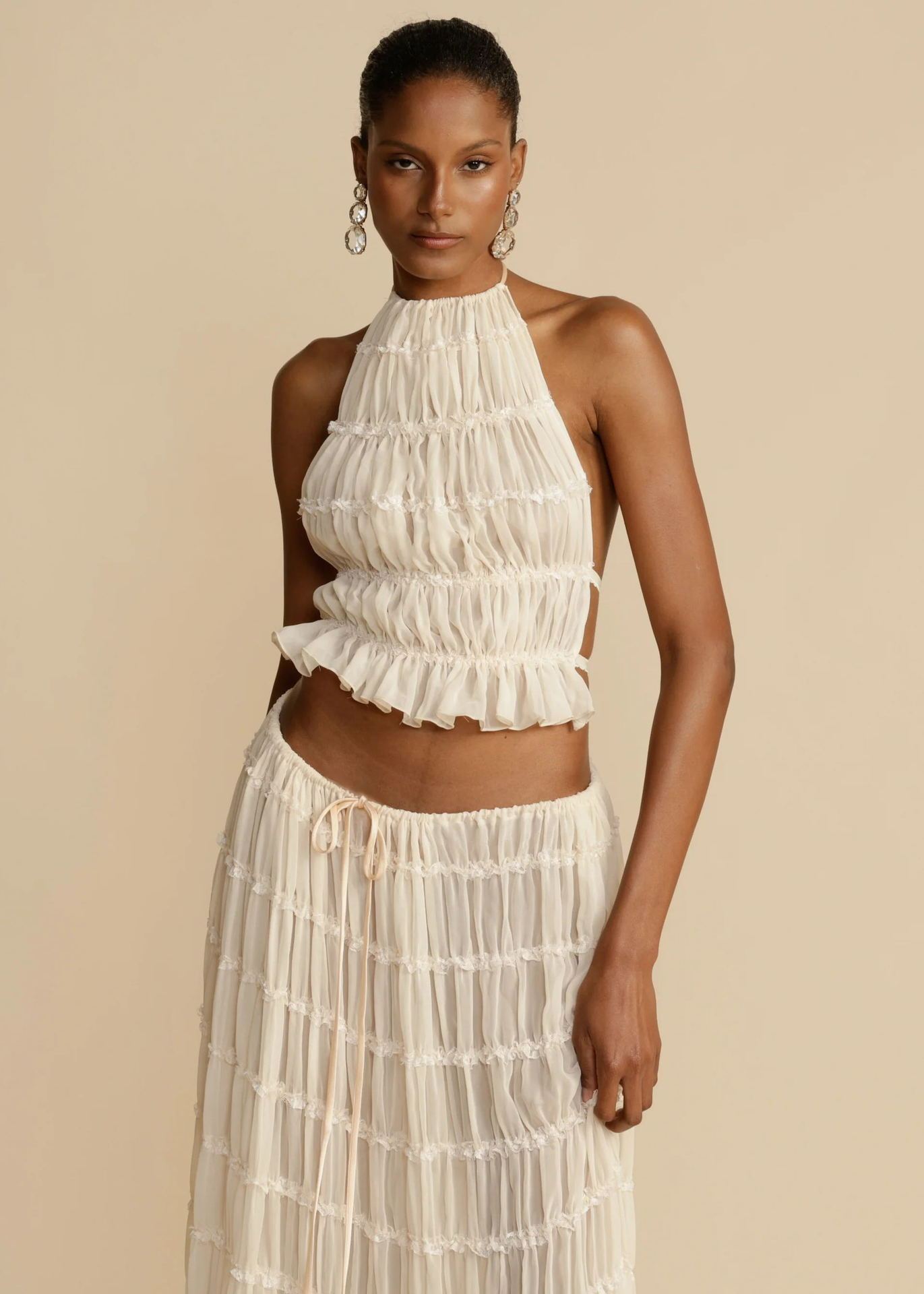 Pleated mini skirt and halter top styled for beach vacation