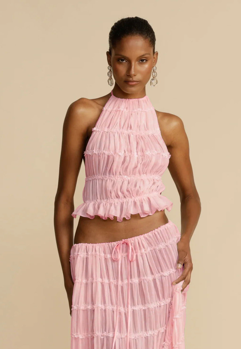 Flirty beachwear set featuring cropped halter and pleats