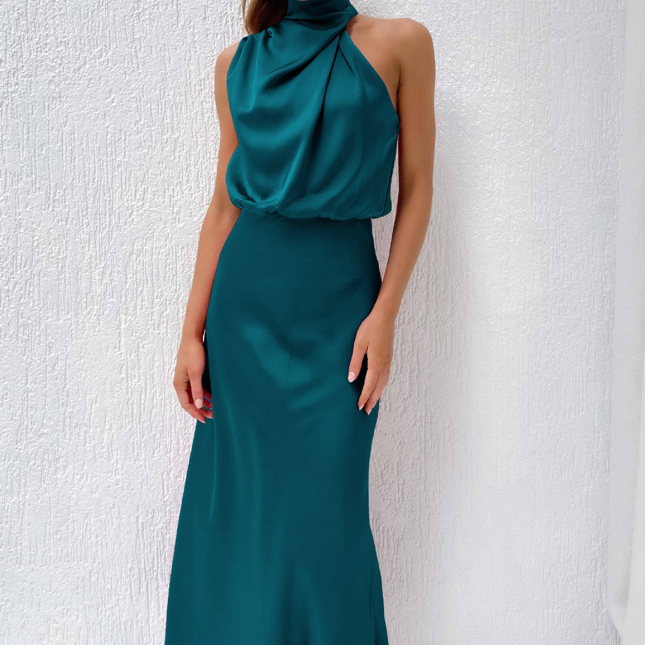 Model in sleek sleeveless dress posing in modern night setting