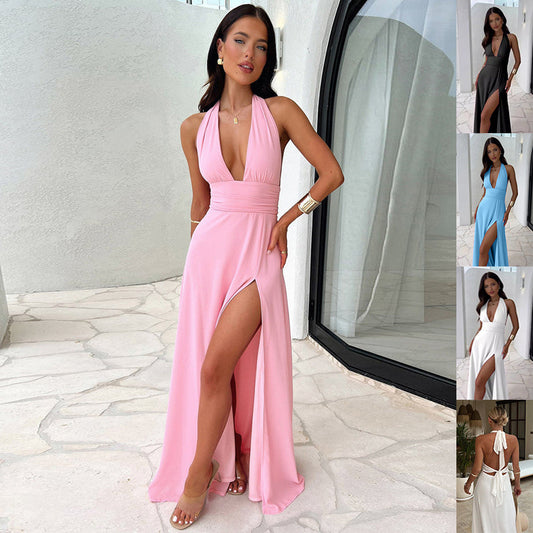 Woman in halter neck slit maxi dress posing on beach