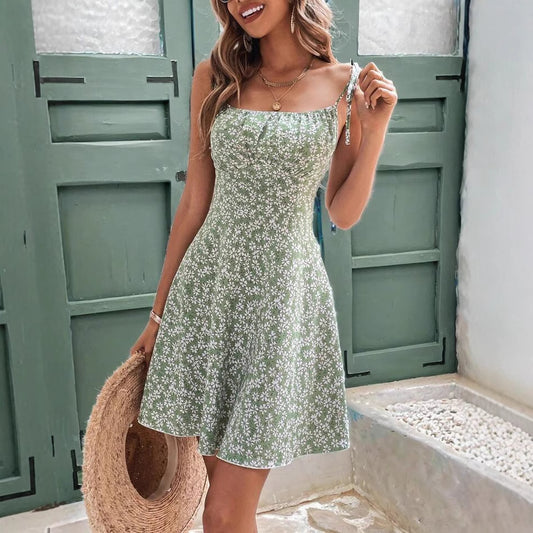 Woman in floral spaghetti strap sundress on sunny beach day