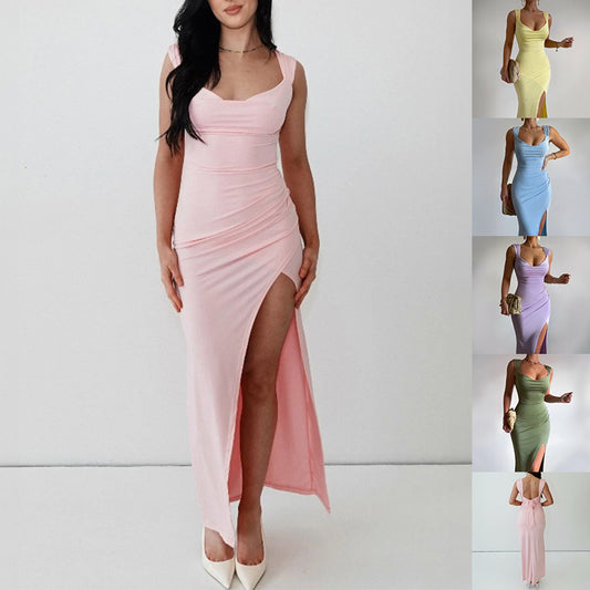 Woman in slim sleeveless dress with side slit and back tie detail