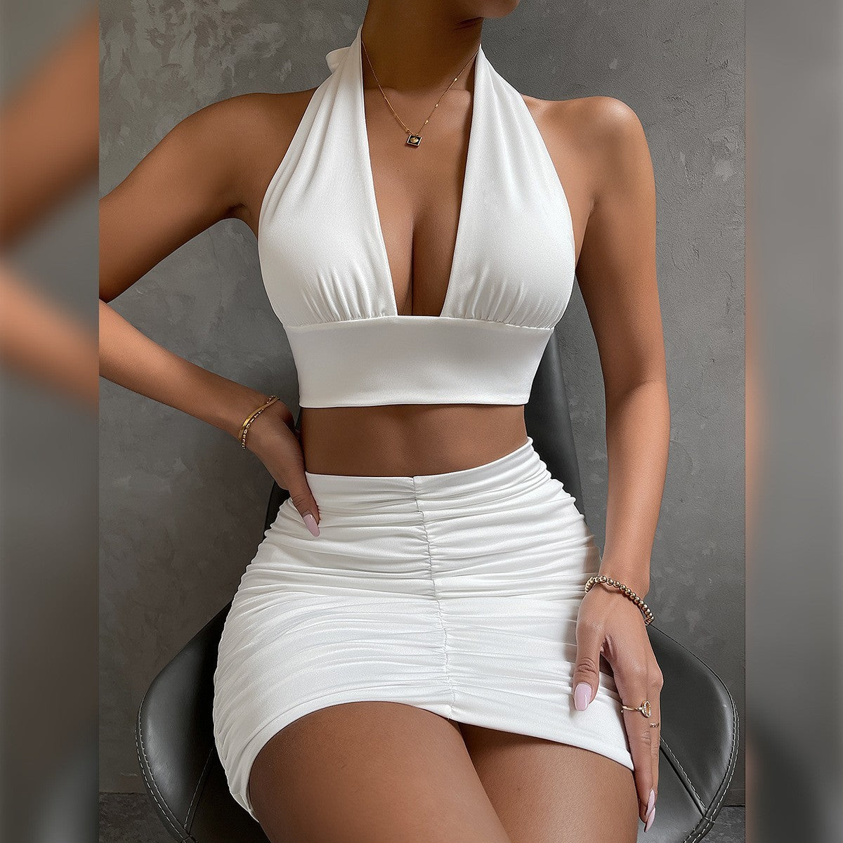Model in coordinated halter top and skirt styled with sandals